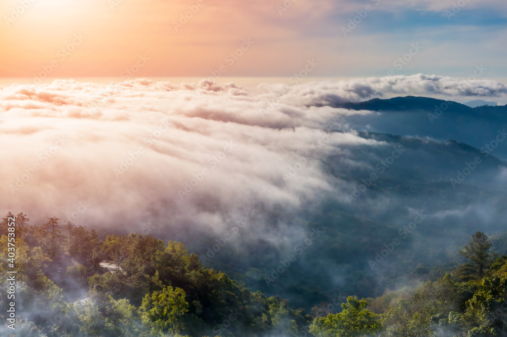 Amazing Sunrise and mist flowing over the mountains , Foggy morning sky with rising sun above misty Inthanon Natural Park Chiang Mai Thailand