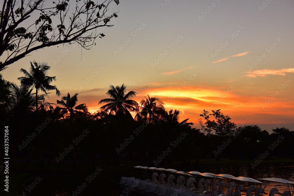 Beautiful golden yellow sky after sunset, Picture of a sun setting in the Formal Garden. Park. Beautiful Garden	