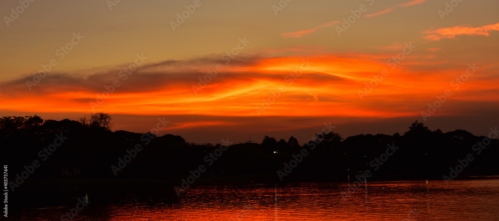 Beautiful golden yellow sky after sunset, Picture of a sun setting in the Formal Garden. Park. Beautiful Garden	