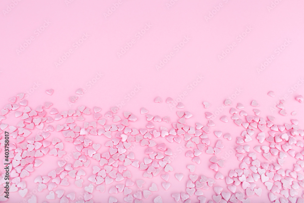 Pink background. Pink hearts on a pink background. Hearts sprinkles. Valentine day. Flat lay style. Top view. Place for design. Sweet background. Confetti. Pink background. Pink hearts on a pink background. Hearts sprinkles. Valentine day. Flat lay style. Top view. Place for design. Sweet background. Confetti.
