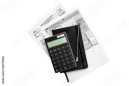 Tax forms with notepad and calculator. Isolated on white.