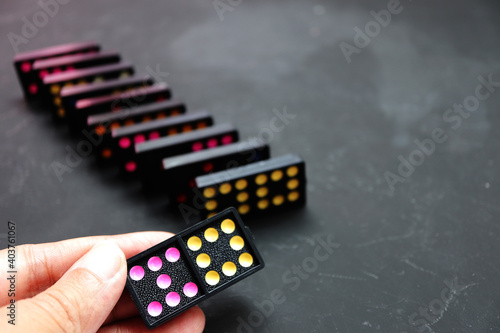 Playing dominoes on a table.