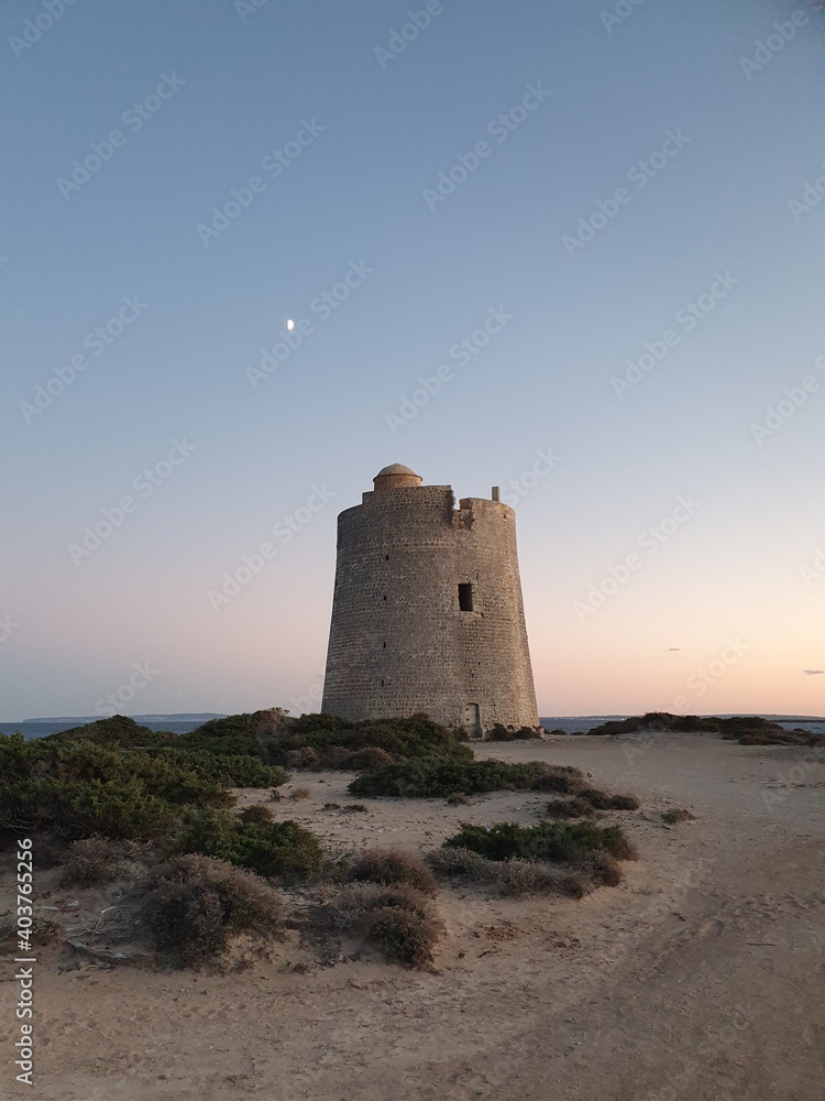 An old tower called 'Torre de ses Portes', tower of the doors, at Las Salinas Beach in Ibiza, Spain