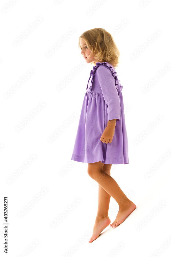 A little girl is photographed in the studio on a cyclorama. A little girl is photographed in the studio on a cyclorama.