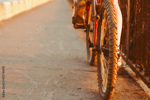 girl rides a bike at sunset