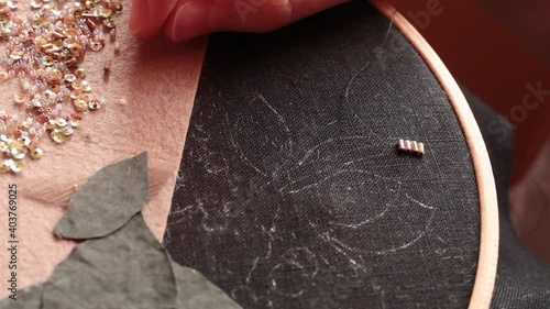 .The embroiderer at work. Couture embroidery of floral motifs photo