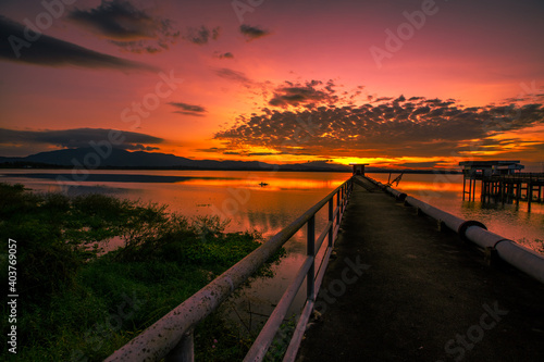 The background of the bridge stretches into the sea, with twilight light in the morning, beautiful colors, sky wallpaper and refreshing surroundings.