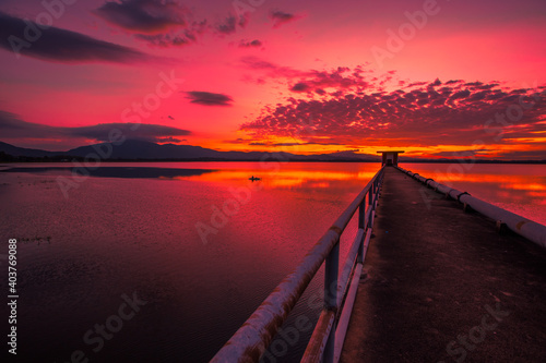 Fototapeta Naklejka Na Ścianę i Meble -  The background of the bridge stretches into the sea, with twilight light in the morning, beautiful colors, sky wallpaper and refreshing surroundings.