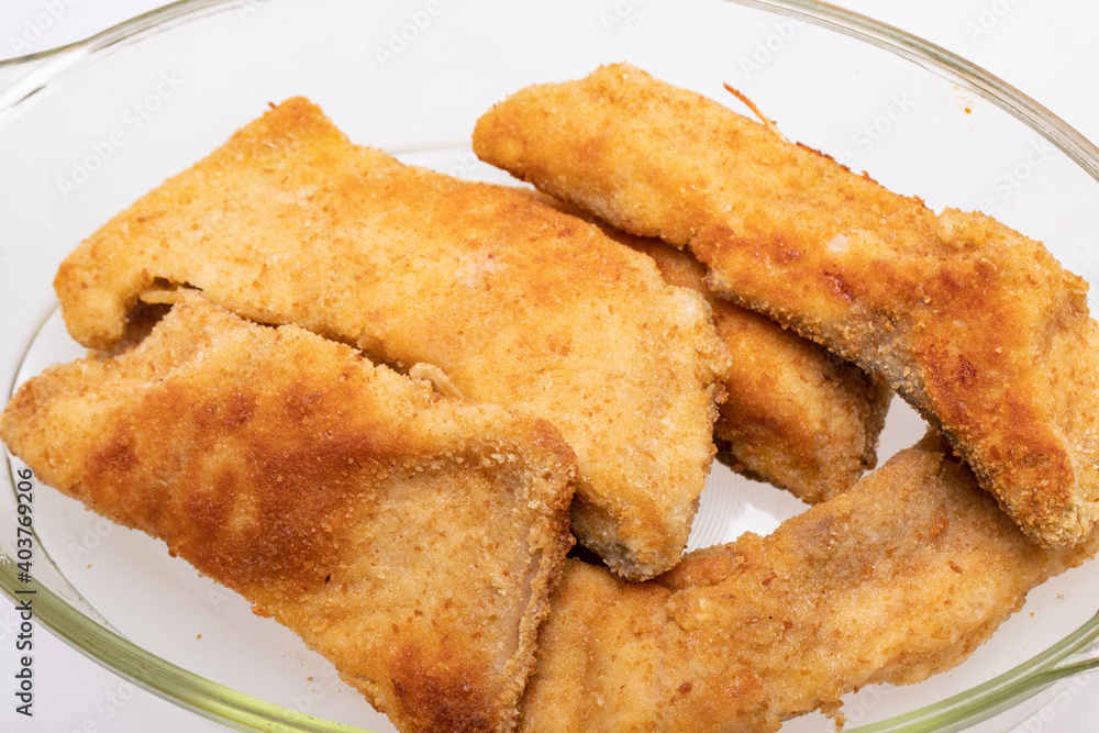 Breaded fish fillets in a glass, heat-resistant dish Breaded fish fillets in a glass, heat-resistant dish