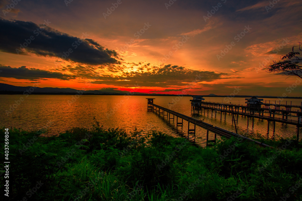 Fototapeta premium The background of the bridge stretches into the sea, with twilight light in the morning, beautiful colors, sky wallpaper and refreshing surroundings.