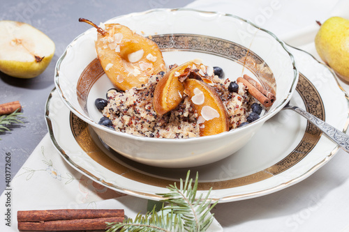 
quinoa porridge with caramelized pear and berries. morning breakfast