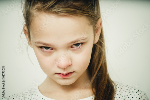 close-up portrait of offended girl on a white background
