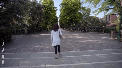Wallpaper Mural Attractive young woman walk in Venice Italy looking at the blue sky Torontodigital.ca