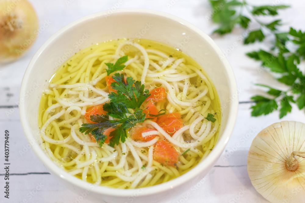 Tasty chicken broth with noodles and vegetables Tasty chicken broth with noodles and vegetables