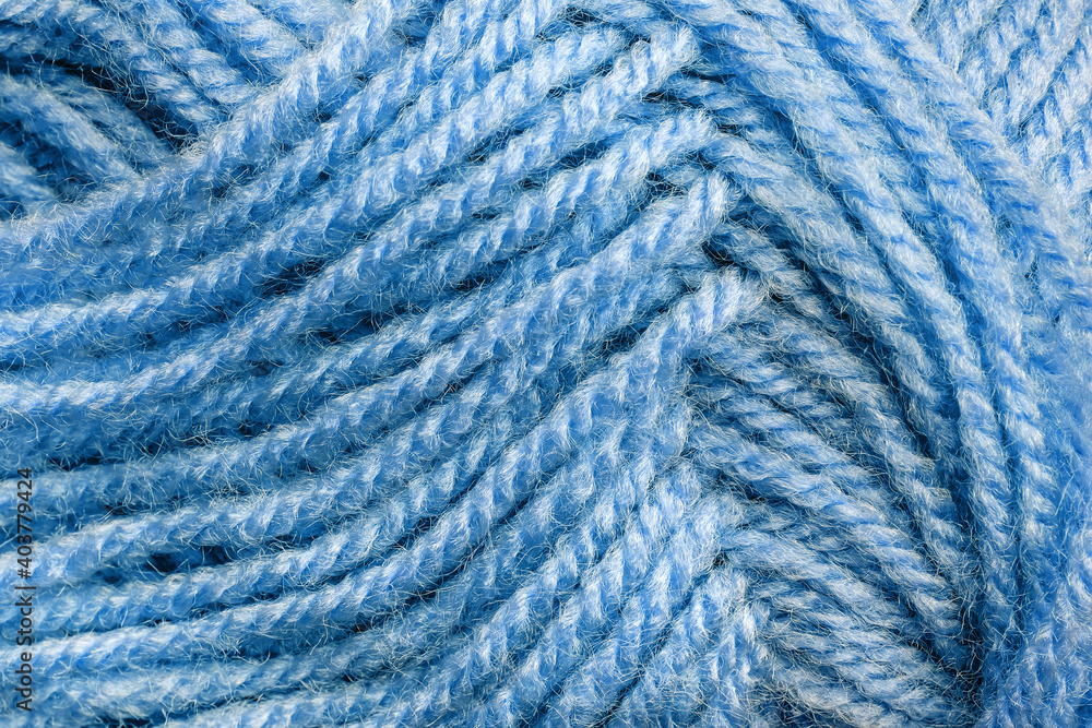 Cropped skein of pale blue woolen knitting thread texture. Ball of soft woolen yarn full frame macro photography. Knitting threads for handicraft and home hobbies background. Close-up design element. Cropped skein of pale blue woolen knitting thread texture. Ball of soft woolen yarn full frame macro photography. Knitting threads for handicraft and home hobbies background. Close-up design element.