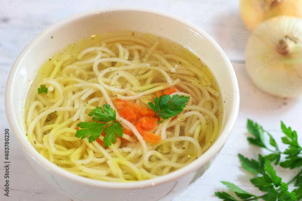 Tasty chicken broth with noodles and vegetables Tasty chicken broth with noodles and vegetables