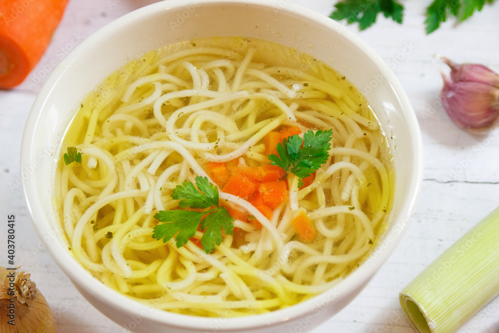 Tasty chicken broth with noodles and vegetables