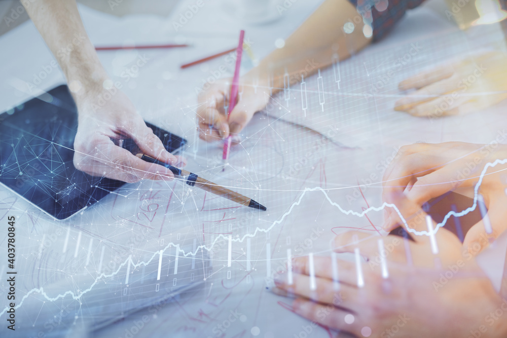 Double exposure of forex graph drawing and man and woman working together holding and using a mobile device. Trade concept.