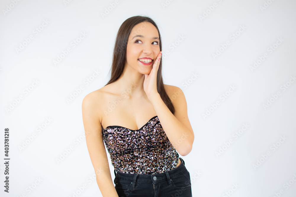 Young celebrating beautiful girl isolated over studio background smiling Young celebrating beautiful girl isolated over studio background smiling