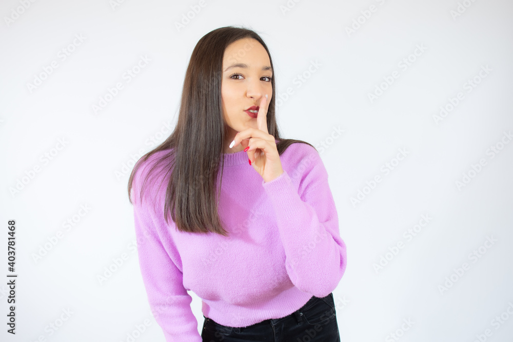 Pretty girl making silence gesture over white background Pretty girl making silence gesture over white background