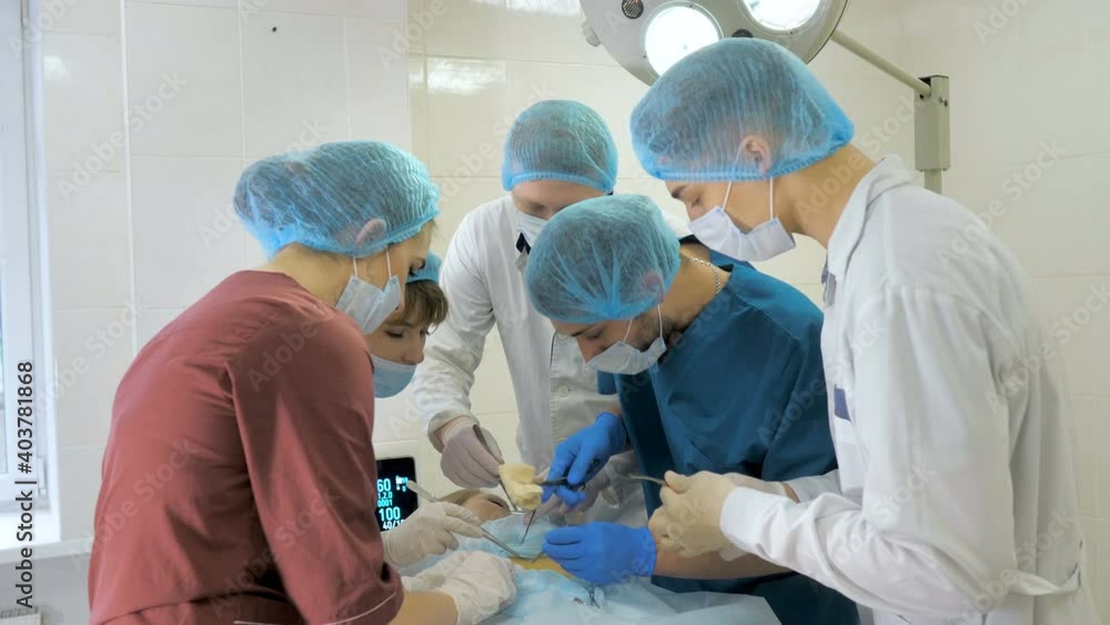 Surgeons are operating. Resuscitation medicine team wearing masks holding medical tools Surgeons are operating. Resuscitation medicine team wearing masks holding medical tools