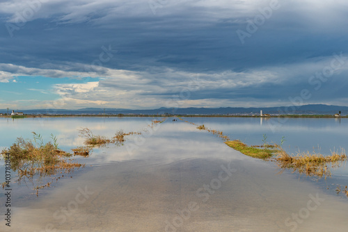 Flooded road under cloudy sky after the storm