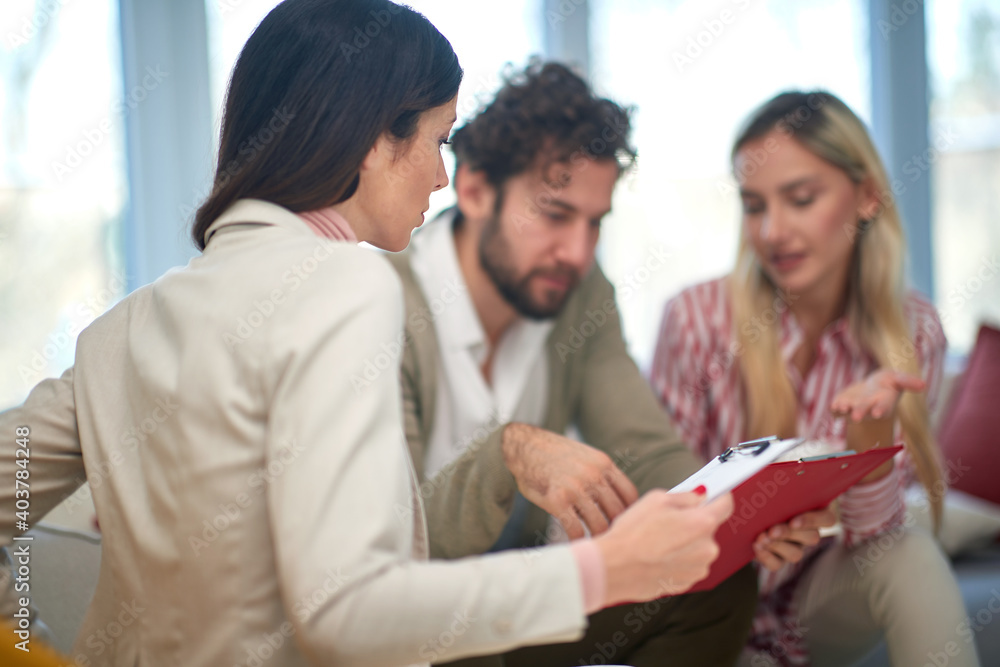 A group of young business people at a meeting discussing some important data from documents. People, business, meeting A group of young business people at a meeting discussing some important data from documents. People, business, meeting