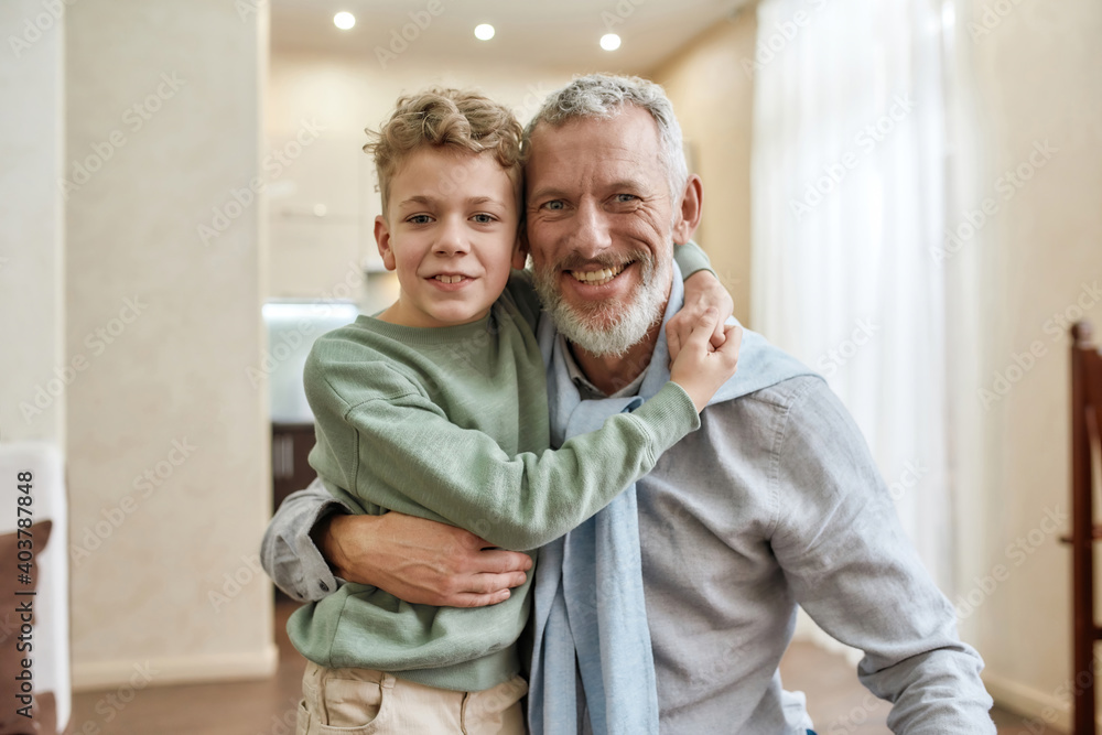 Φωτογραφία Happy grandfather embracing with his cute little preschool grandson, standing to