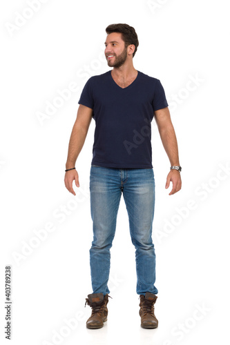 Handsome Casual Man Is Standing, Relaxed, Looking Away And Smiling