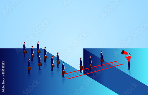The leader helps and inspires a group of businessmen to walk through the gully