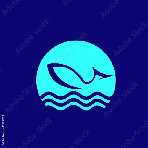 Fish logo.Bright neon blue color icon isolated on dark background.Symbol for fishing business and water sports.Aquatic animal shape in the moonlight.