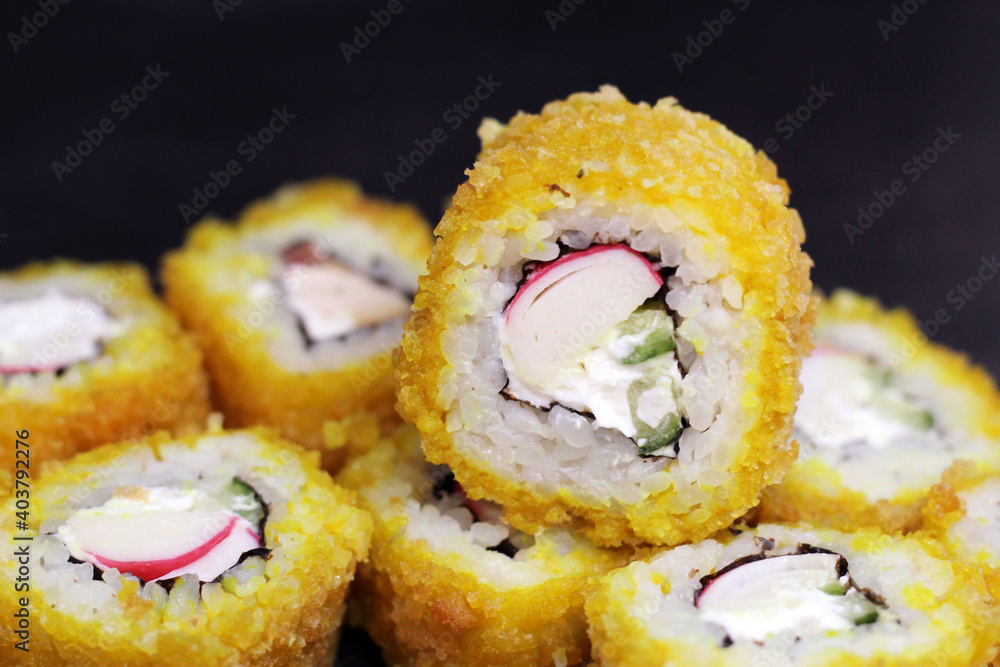 Hot Sushi rolls made of rice, smoked eel, cream cheese and flying fish roe - tobiko caviar Hot Sushi rolls made of rice, smoked eel, cream cheese and flying fish roe - tobiko caviar