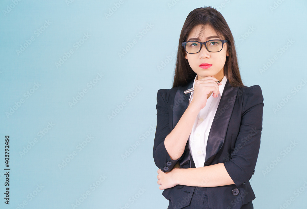 Young asian girl wearing suit with support hand on chin Young asian girl wearing suit with support hand on chin