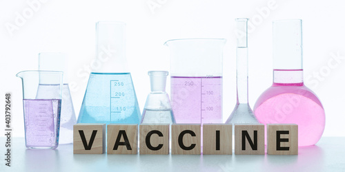 Vaccine word. Text on building blocks with reflection. Vaccination and immunization concept. Medicine and health care. Vaccine trials and research. Pharmacy
