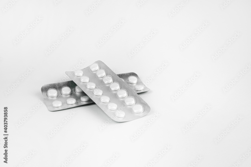 Pills in transparent packaging on a white background Pills in transparent packaging on a white background