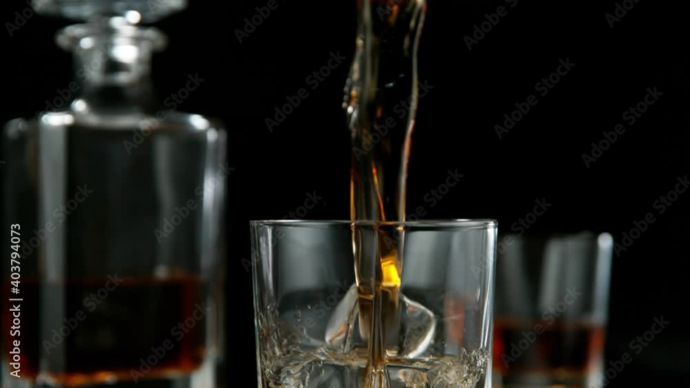 Super slow motion of pouring whiskey or rum with camera motion. Filmed on high speed cinema camera, 1000 fps.