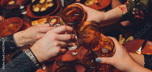 фотографія Clinking glasses with alcohol and toasting, party.