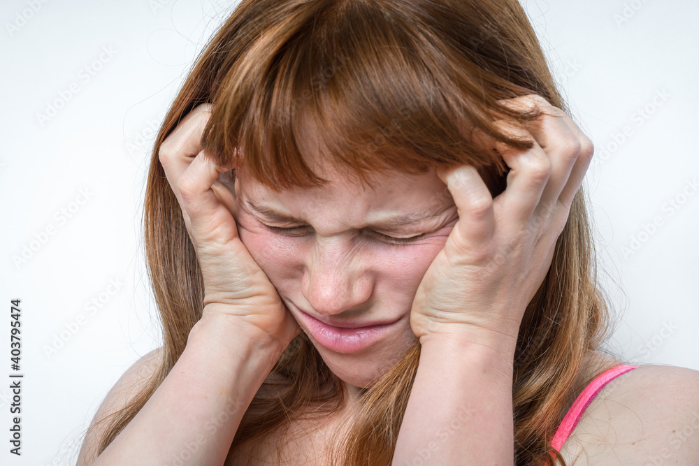 Woman with headache or migraine is holding her aching forehead Woman with headache or migraine is holding her aching forehead