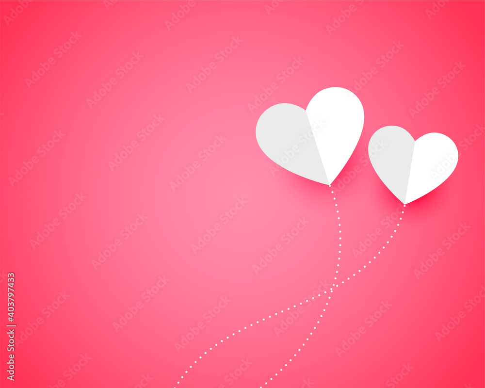 two paper hearts on pink background with text space