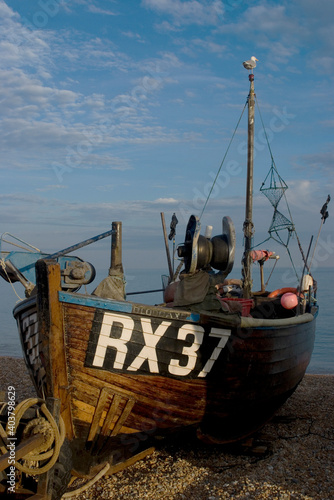 Fishing boat on pebble beach photo