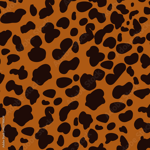 Brown cheetah spots on orange background. Animal seamless pattern. Repeating pattern.