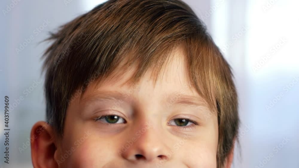 Close-up face of Caucasian preschooler boy holding paper figurines in the shape of heart. Congratulations on Valentine's Day. First love for Valentine's Day. Selective focus, shallow depth of field Close-up face of Caucasian preschooler boy holding paper figurines in the shape of heart. Congratulations on Valentine's Day. First love for Valentine's Day. Selective focus, shallow depth of field