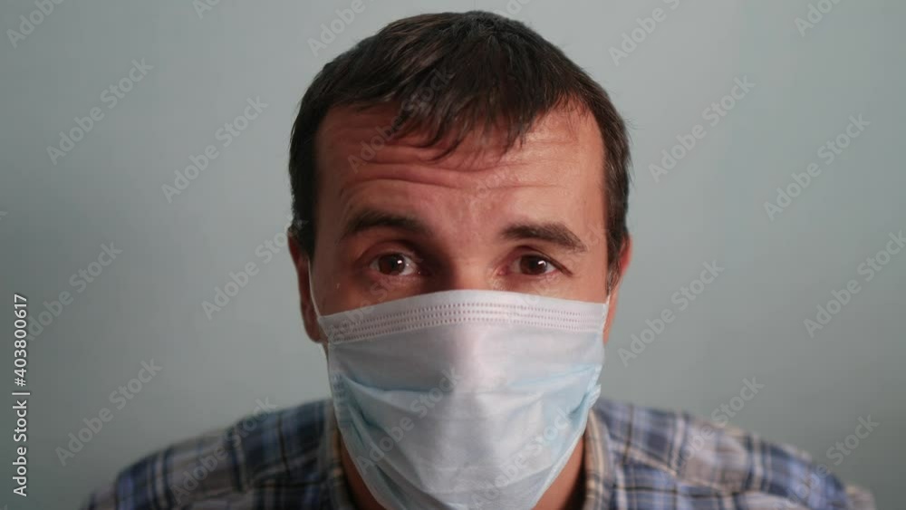man wear protective mask a indoor portrait. epidemic corona outbreak concept. male 37 years old brunette in blue medical mask isolated. Coronavirus disease. dad teamwork self-isolation in home Virus man wear protective mask a indoor portrait. epidemic corona outbreak concept. male 37 years old brunette in blue medical mask isolated. Coronavirus disease. dad teamwork self-isolation in home Virus