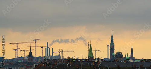 Copenhagen skyline with the towers of the city in a orange sunset.