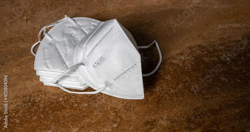 FFP2 KN95 Face mask on travertine background. Protection against Coronavirus Covid-19 coronavirus