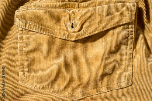 Trouser pocket, close-up. Corduroy yellow texture. Copy space. Beautiful background. 