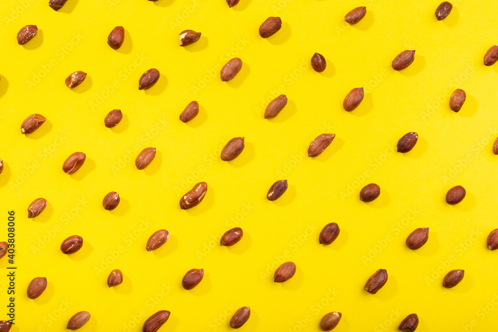Peanuts pattern isolated on a yellow backround. Repetition concept. Peanuts pattern isolated on a yellow backround. Repetition concept.