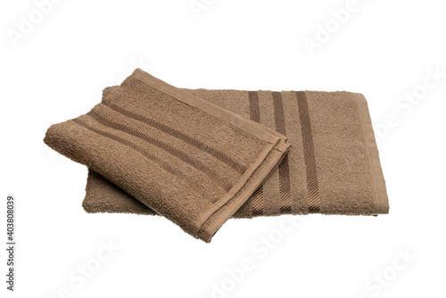 stack of brown towels isolated on white.