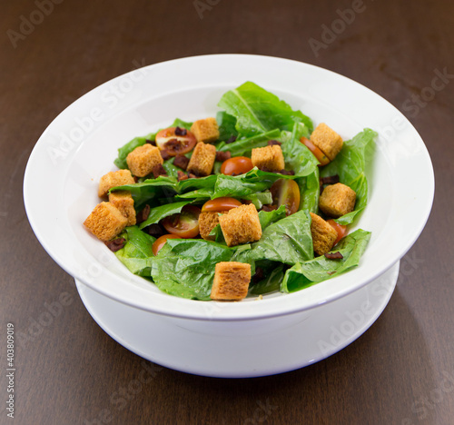 Vegetable salad topped with white bowl of fiber bread