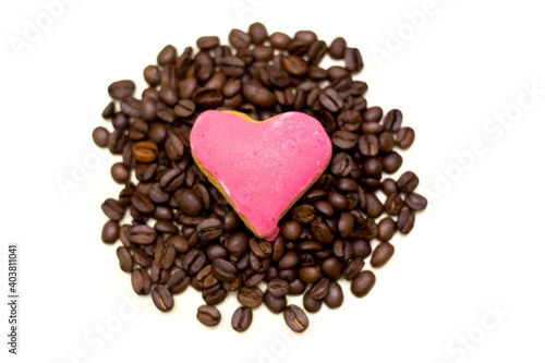 Coffee beans with a heart-shaped biscuit. white background. © CRISTINA